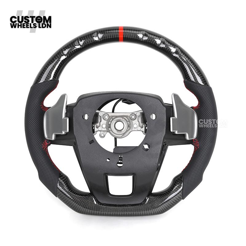 Toyota Custom Hilux Flat Bottom Steering Wheel – Carbon Fiber & Perforated Leather with Red Center Stripe | Fits 2021+ Hilux Models | Plug & Play | Premium Upgrade for Off-Road & Daily Driving | Made to Order | Performance Look & Feel