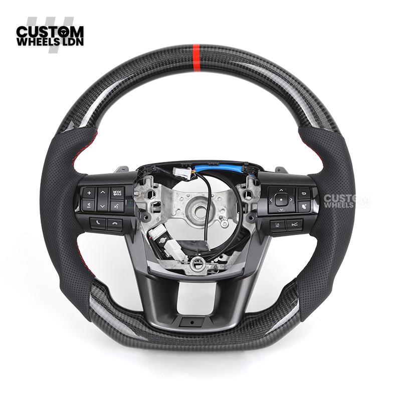 Toyota Custom Hilux Flat Bottom Steering Wheel – Carbon Fiber & Perforated Leather with Red Center Stripe | Fits 2021+ Hilux Models | Plug & Play | Premium Upgrade for Off-Road & Daily Driving | Made to Order | Performance Look & Feel