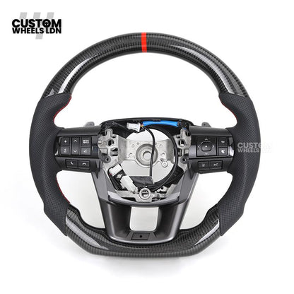 Toyota Custom Hilux Flat Bottom Steering Wheel – Carbon Fiber & Perforated Leather with Red Center Stripe | Fits 2021+ Hilux Models | Plug & Play | Premium Upgrade for Off-Road & Daily Driving | Made to Order | Performance Look & Feel