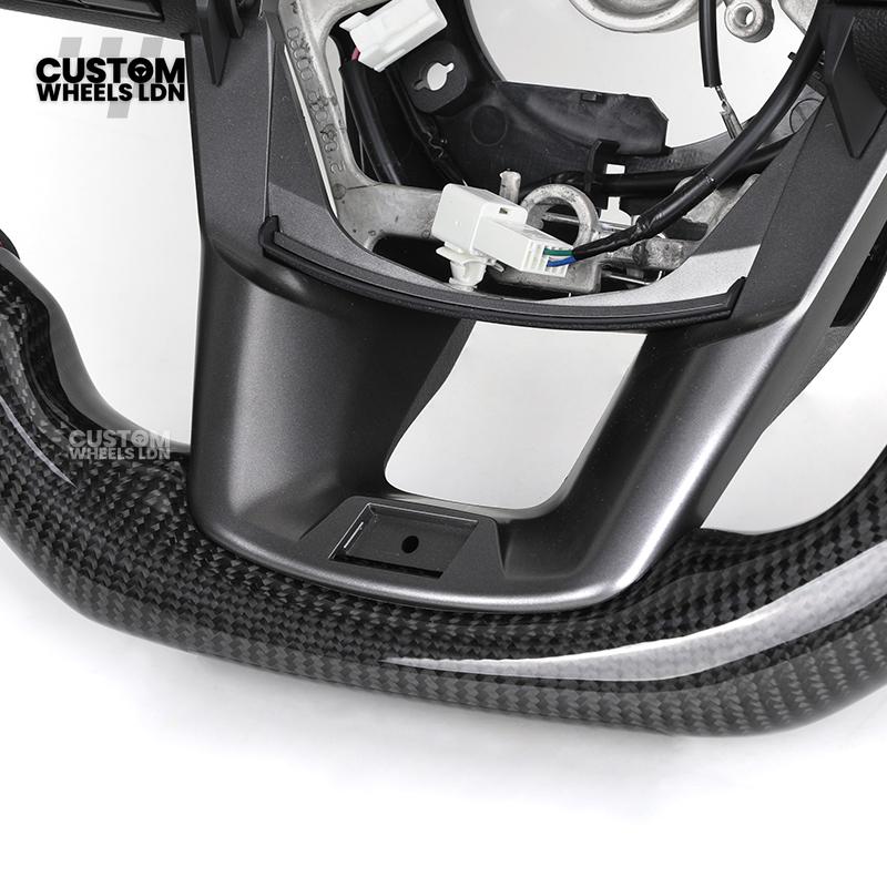 Toyota Custom Hilux Flat Bottom Steering Wheel – Carbon Fiber & Perforated Leather with Red Center Stripe | Fits 2021+ Hilux Models | Plug & Play | Premium Upgrade for Off-Road & Daily Driving | Made to Order | Performance Look & Feel